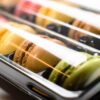 Close-up of colorful French macarons in a plastic box, ready to enjoy.
